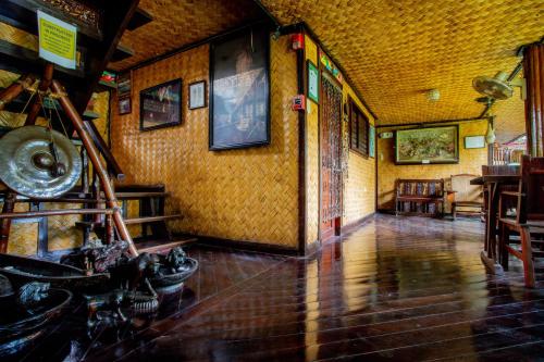 a room with a hallway with a table and chairs at Puerto Pension Inn in Puerto Princesa City