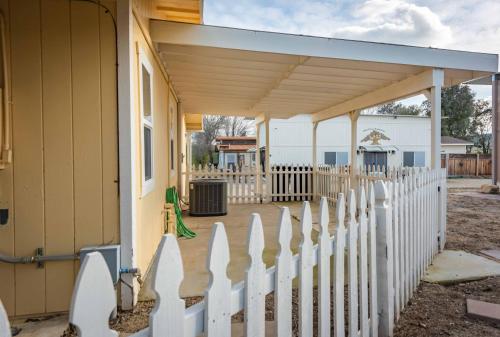 a white picket fence in front of a house at Oak Pass Ranch in Paso Robles