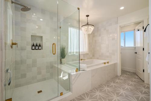 a bathroom with a shower and a tub and a sink at Mira Vista Manor in Paso Robles