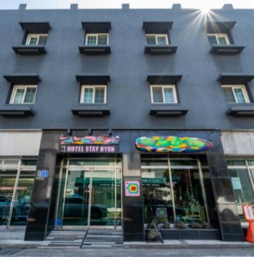 a large black building with a store front with windows at Stay Hyun in Jeju