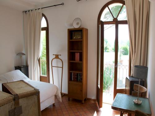 a bedroom with a bed and a book shelf at La Ferme Rose-Hôtel de Charme in Moustiers-Sainte-Marie