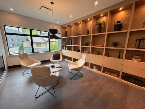 a living room with chairs and a table and shelves at RED Mountain Suite in Rossland