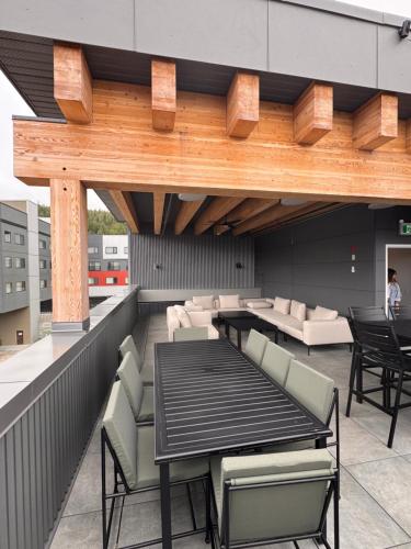a patio with a table and chairs on a roof at RED Mountain Suite in Rossland