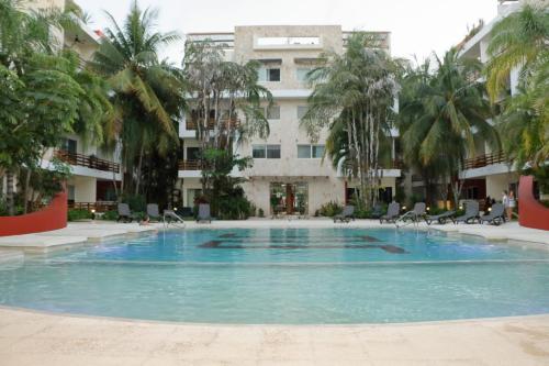 ein großes Schwimmbad vor einem Gebäude in der Unterkunft Grand Blue Playa in Playa del Carmen