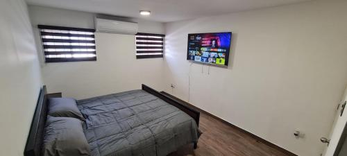 a bedroom with a bed and two windows at Casa cómoda y completa con 2 camas king size y 1 cama twin in Ciudad Juárez