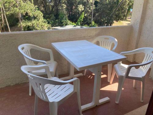 a white table and chairs on a porch with a table and chairs at Apartment in Rosolina Mare 25092 in Rosolina Mare