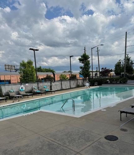 a large swimming pool with benches at Cozy Contemporary Condo in Atlanta
