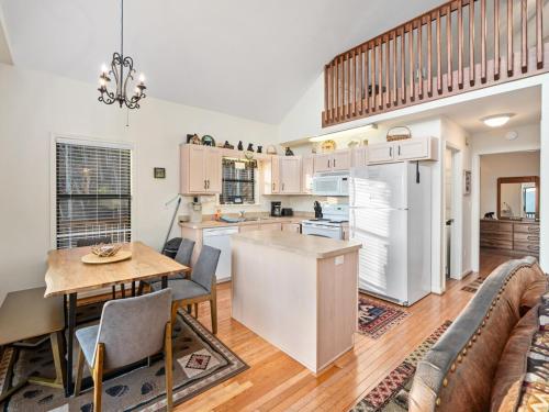 a kitchen and living room with a table and a couch at Lazy Bear Retreat Mountain Views-Hot Tub-FirePit in Whittier