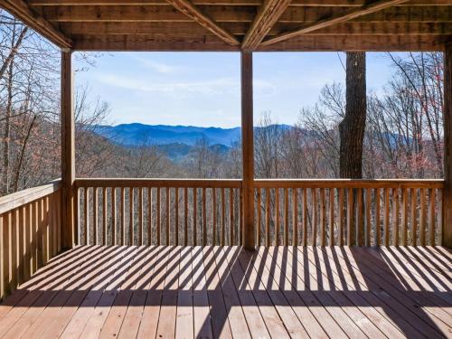 a screened in porch with a view of the mountains at Lazy Bear Retreat Mountain Views-Hot Tub-FirePit in Whittier