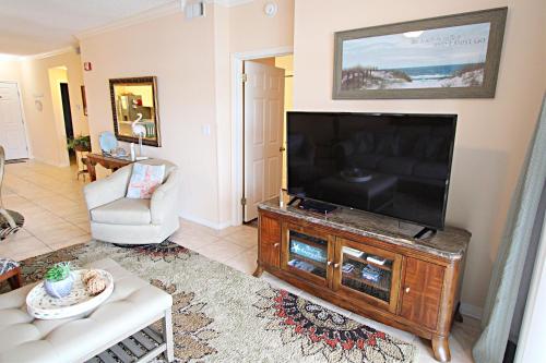 a living room with a large flat screen tv at Cypress Point in Gulf Shores