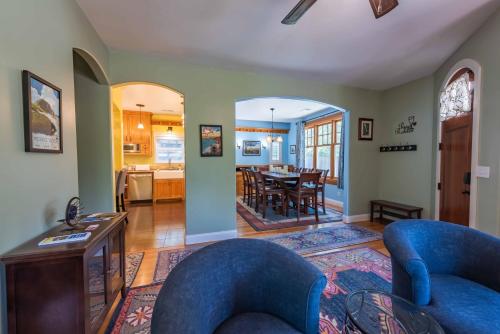 a living room with two blue chairs and a dining room at Crafty Oak House in Paso Robles