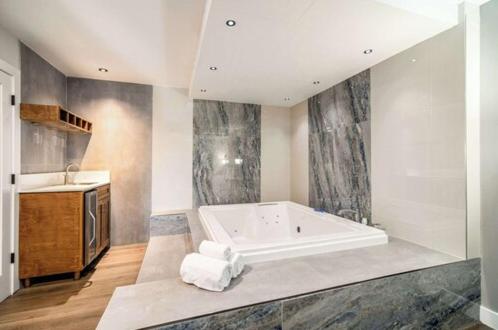 a large bathroom with a tub and a sink at MainStay Suites Moreno Valley Near March Air Reserve Base in Moreno Valley