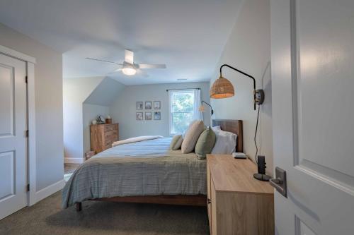 a bedroom with a bed with a desk and a window at Sycamore Ranch in Templeton