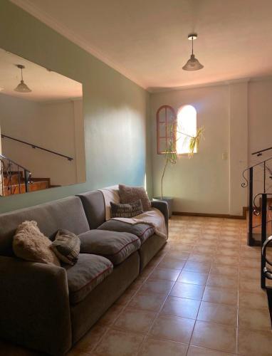 a living room with a couch and a tile floor at Hotel Sienna in Mendoza