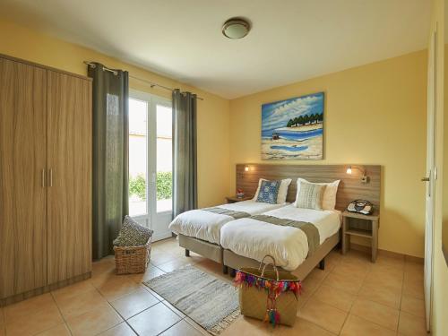 a bedroom with a bed and a large window at Villa in France with Garden & Barbecue in Les Forges