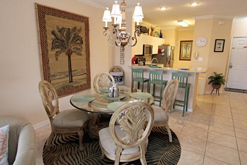 a dining room and kitchen with a table and chairs at Cypress Point in Gulf Shores