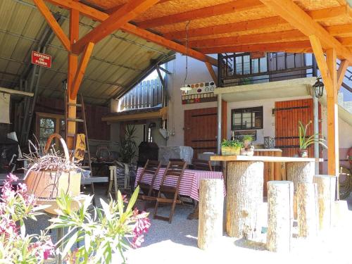 a patio with a table and chairs in a building at Holiday flat in Morschwiller in Morschwiller