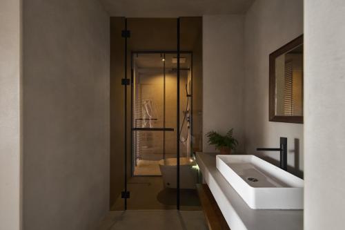 a bathroom with a sink and a toilet and a shower at Lugu Lake Manchen Vacation Homestay in Ninglang
