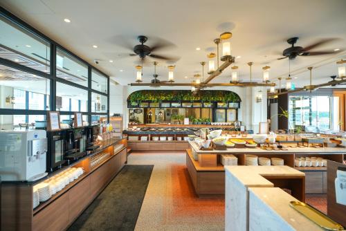 a restaurant with a bakery with tables and windows at Solaria Nishitetsu Hotel Seoul Myeongdong - Renovated in 2025 in Seoul