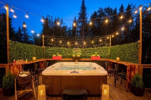 a jacuzzi tub in a patio with lights at Ask us for our immersive 3D virtual tour before reservation in Lac-Superieur