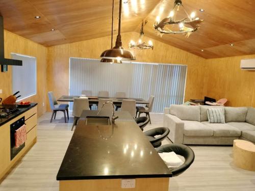 a living room with a table and a couch at Brand New 4BR Alpine Home Near Turoa Ski Field in Ohakune