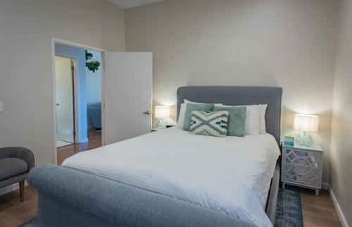 a bedroom with a large bed and a chair at Casa del Lago in Atascadero