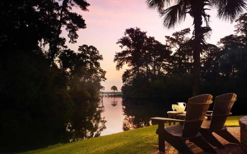 a table and chairs next to a body of water at Signature 4 Bedroom Residence 1033 in Bluffton