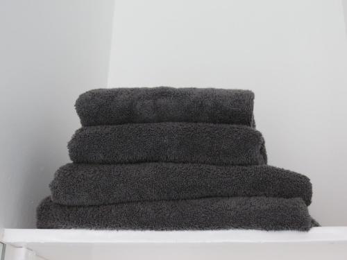 a stack of black towels sitting on a shelf at City Centre-Great Location-Parking - Fast WiFi in Belfast