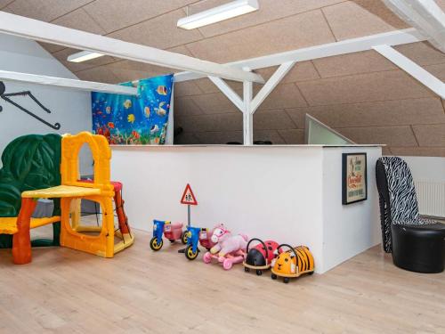 a room with toys on the floor and a wall at 4 star holiday home in Henne in Henne
