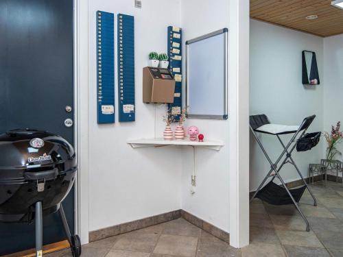a room with a wall with a table and a grill at 4 star holiday home in Henne in Henne
