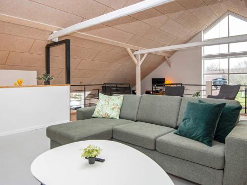 a living room with a couch and a table at 4 star holiday home in Henne in Henne
