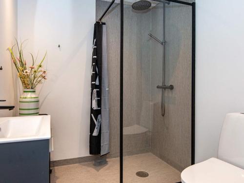 a shower with a glass door in a bathroom at 4 star holiday home in Nørre Nebel in Nørre Nebel