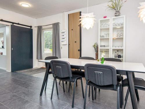 a dining room with a table and chairs at 4 star holiday home in Nørre Nebel in Nørre Nebel