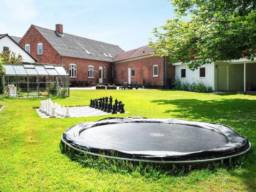 an empty trampoline in the yard of a building at 4 star holiday home in Nørre Nebel in Nørre Nebel