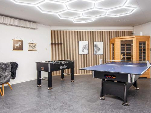a room with two ping pong tables in it at 4 star holiday home in Nørre Nebel in Nørre Nebel