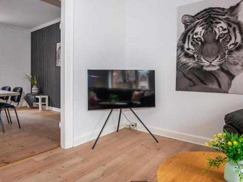 a living room with a picture of a tiger on the wall at 4 star holiday home in Nørre Nebel in Nørre Nebel