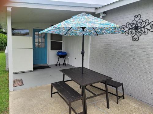a picnic table with an umbrella on a patio at The Peaceful One in Foley
