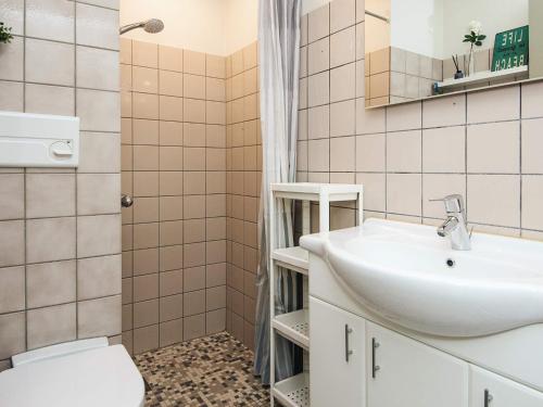 a bathroom with a sink and a toilet at 4 person holiday home in Ringkøbing in Ringkøbing