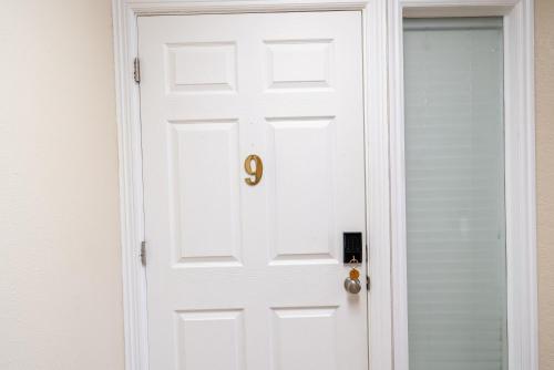 a white door with the number on it at Road Creek Inn in Loa
