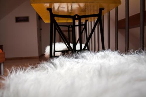 a table in a room with a white rug at Guesthouse S in Luče