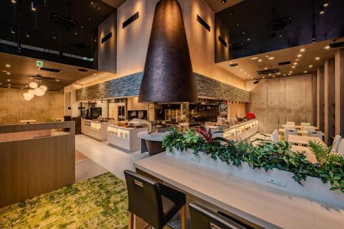 a large kitchen with a large bell above a counter at Richmond Hotel Kagoshima Tenmonkan in Kagoshima