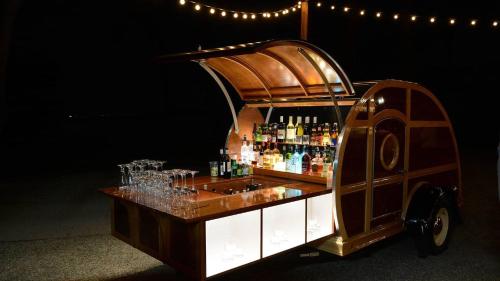 a bar cart with bottles and glasses on it at Signature 4 Bedroom Residence 1033 in Bluffton