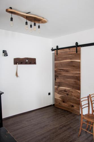a room with a wooden door and a surfboard on the wall at Guesthouse S in Luče