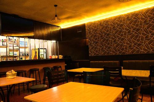 a restaurant with tables and chairs and a bar at Lion Hill Place in Nakuru