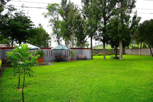 a yard with a tent and a park with green grass at Lion Hill Place in Nakuru