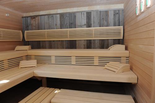 a sauna with wooden walls and wooden benches at Landhotel Wilder Mann in Eggingen