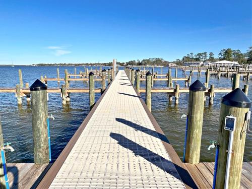 a dock on a body of water with birds on it at Bayview in Orange Beach