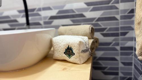 a bathroom with towels on a counter next to a tub at Vikendica Cerović in Kraljevo