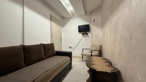 a living room with a couch and a chair at Vikendica Cerović in Kraljevo
