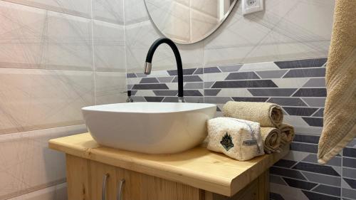 a bathroom with a white bowl sink and a faucet at Vikendica Cerović in Kraljevo